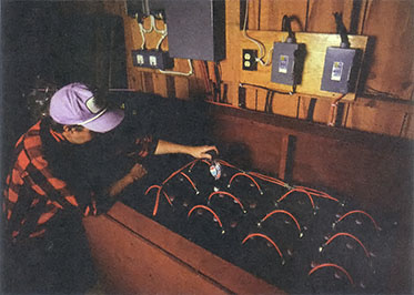 Sunelco's Dan Brandborg checks the battery power of the Selway Lodge. The 16 batteries yield 1,400 amp-hours of storage
